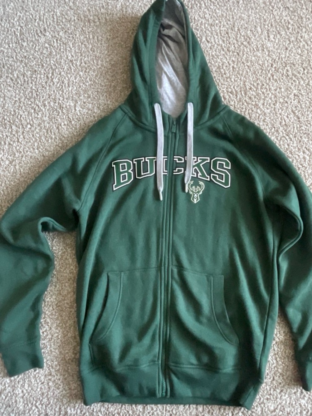 Green Antigua full-Zip Hoodie with the Milwaukee bucks logo and “BUCKS” on it